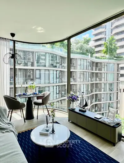 Modern living room with floor-to-ceiling windows and stunning city view