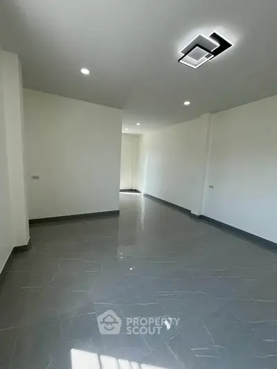 Spacious unfurnished room with modern lighting and tiled flooring