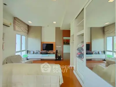 Spacious living room with modern decor and large windows for natural light