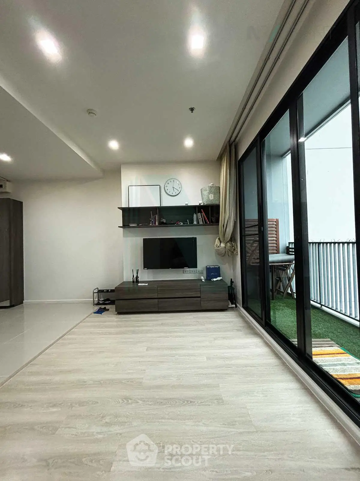 Modern living room with sleek design and large balcony access, perfect for urban living.