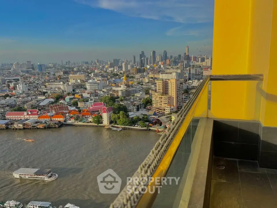 Stunning cityscape view from a high-rise balcony overlooking a river, perfect for urban living enthusiasts.