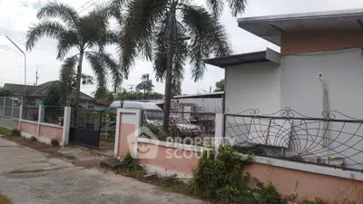 Charming suburban home with palm trees and gated entrance, perfect for tranquil living.