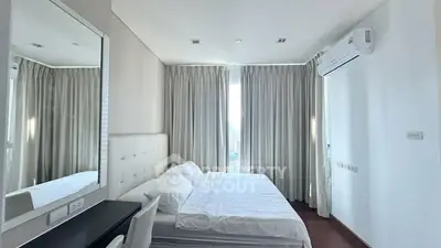 Modern bedroom with large window and elegant decor