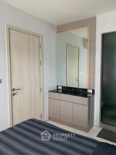Modern bedroom with sleek mirror and stylish cabinet design