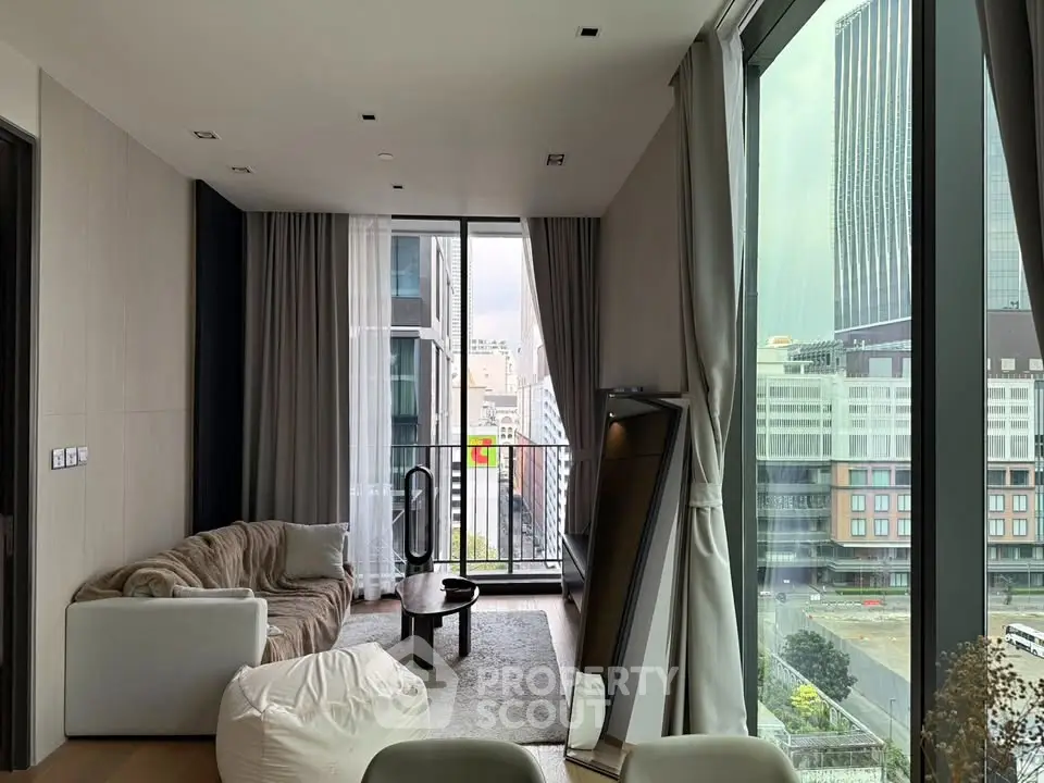 Modern living room with floor-to-ceiling windows and city view, featuring cozy seating and elegant decor.