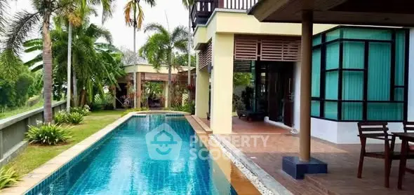 Luxurious villa with private pool and lush garden, perfect for tropical living.