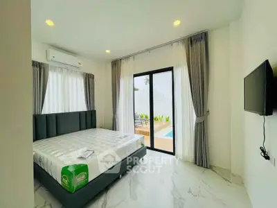 Modern bedroom with pool view and sleek design
