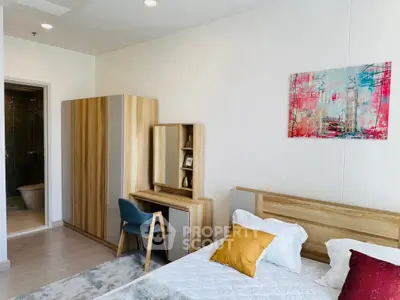 Modern bedroom with stylish wooden furniture and colorful artwork, featuring a cozy bed and a sleek wardrobe.