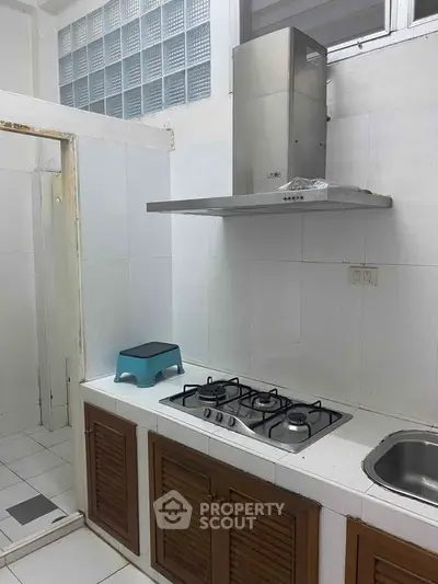 Compact kitchen with gas stove and sleek cabinetry, perfect for efficient cooking in a modern home.
