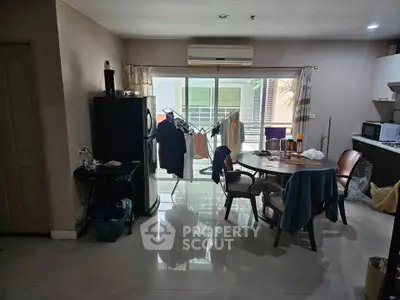 Spacious kitchen and dining area with modern appliances and balcony access.