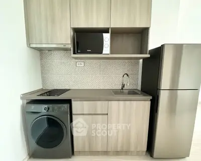 Modern compact kitchen with sleek appliances and stylish cabinetry