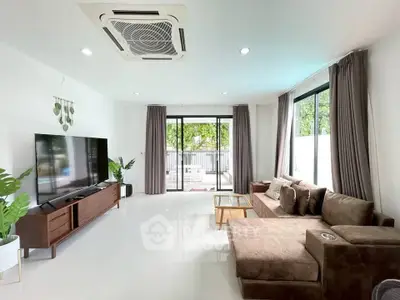 Spacious living room with modern decor and large windows for natural light.