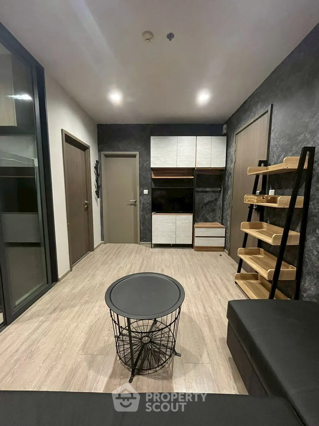 Modern living room with sleek furniture and stylish shelving in a contemporary apartment.