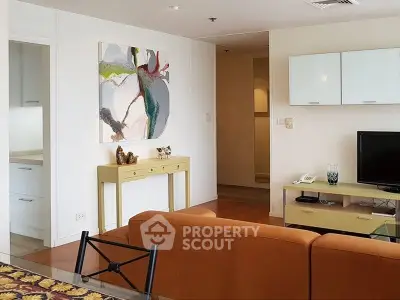 Modern living room with stylish decor and open layout, featuring a cozy sofa and contemporary artwork.