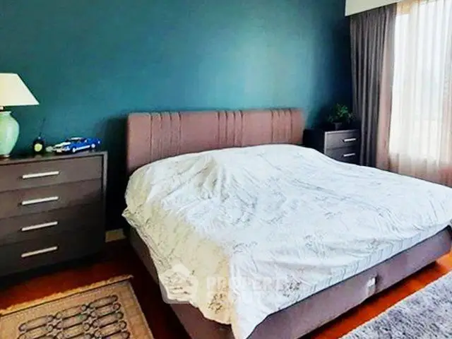 Spacious bedroom with modern decor and natural light