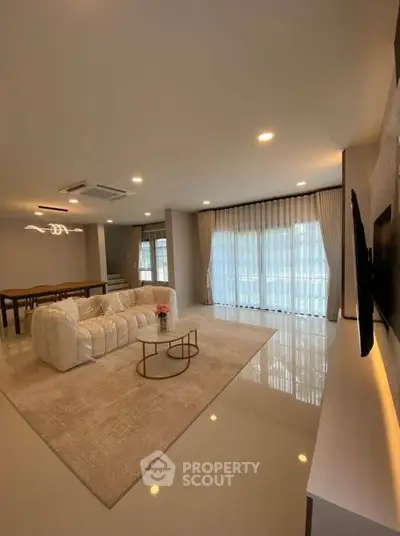 Spacious modern living room with elegant decor and large windows
