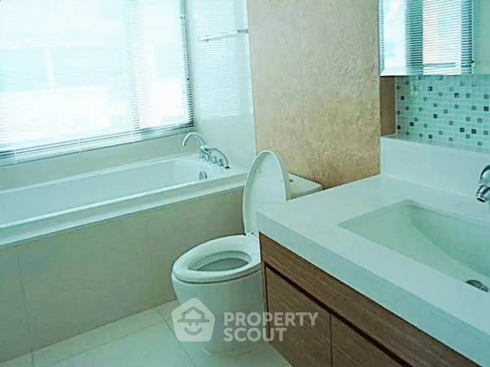 Modern bathroom with sleek fixtures and large bathtub in a bright, airy space.