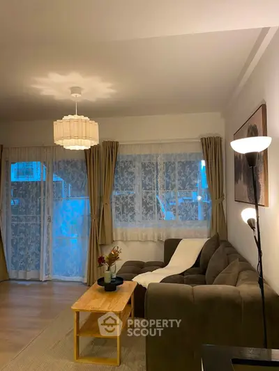 Cozy living room with elegant lighting and plush sofa, perfect for relaxation and entertaining guests.