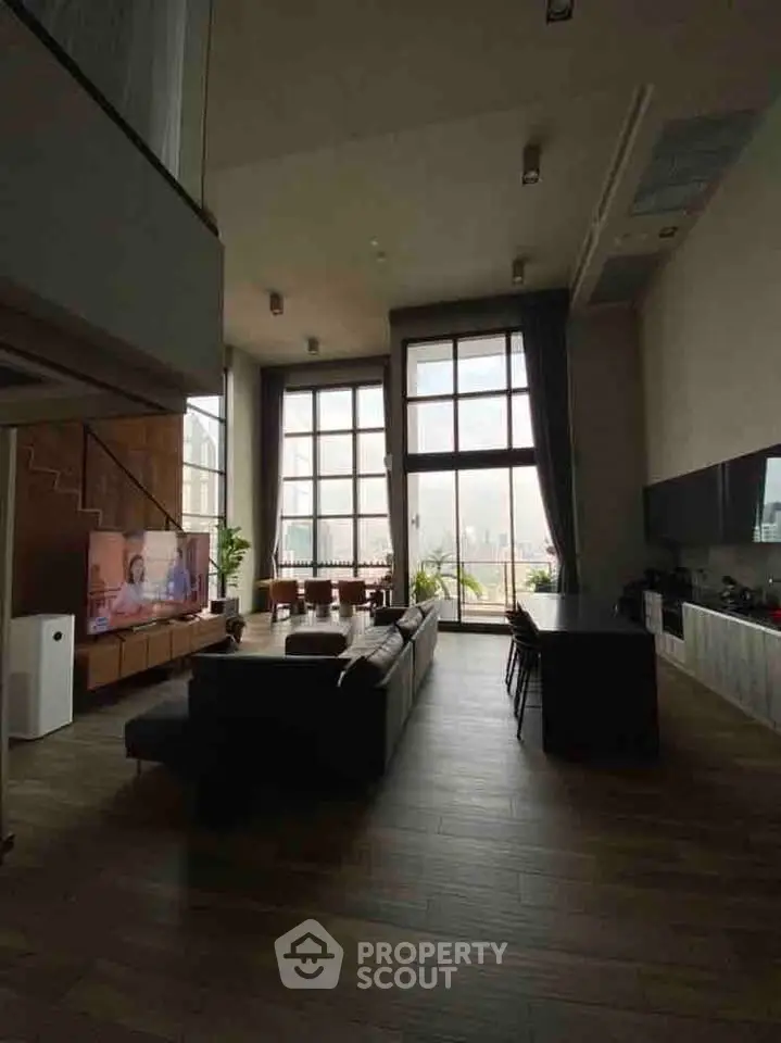 Spacious modern living room with high ceilings and large windows