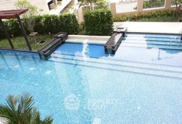 Luxurious outdoor swimming pool with elegant design and lush greenery, perfect for relaxation and leisure.