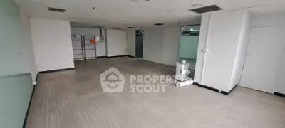 Spacious commercial office space with modern flooring and ample natural light.