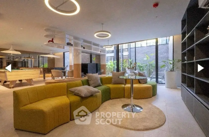 Luxurious modern living room with stylish furniture and large windows offering natural light.