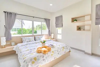 Bright and airy bedroom with modern decor and large windows