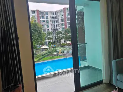Luxurious apartment with pool view from spacious balcony, perfect for relaxation and leisure.