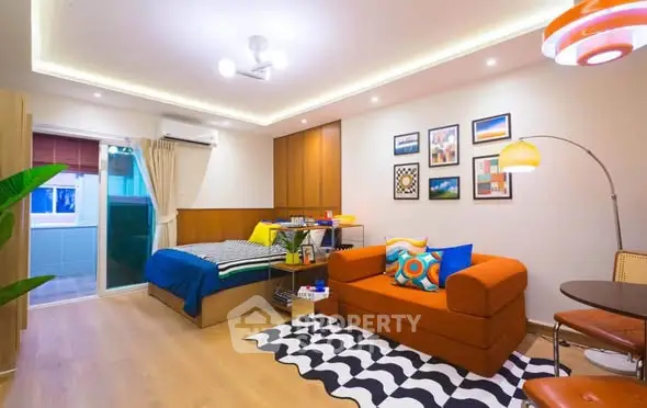 Modern studio apartment with vibrant decor and cozy living space