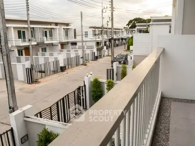 Modern townhouse balcony with street view in a serene neighborhood