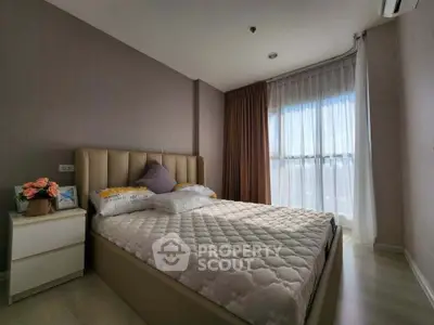 Modern bedroom with large window and elegant decor, featuring a comfortable bed and stylish curtains.
