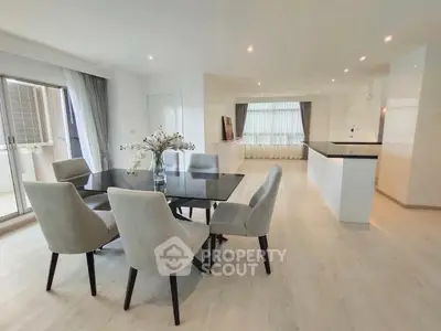 Spacious modern dining area with elegant decor and open kitchen layout in luxury apartment.