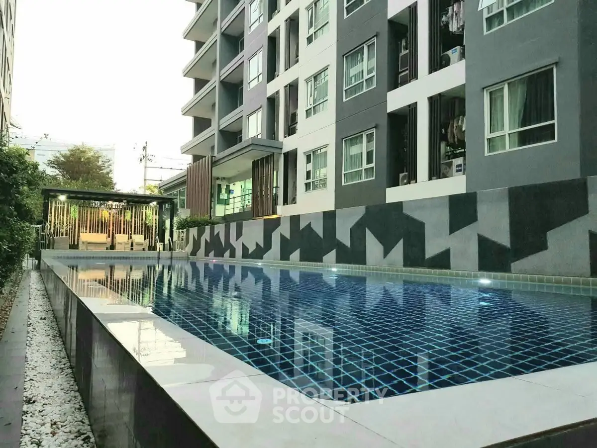 Modern apartment building with a sleek outdoor pool and stylish design.