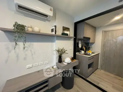Modern kitchen with sleek cabinetry and air conditioning unit, perfect for urban living.