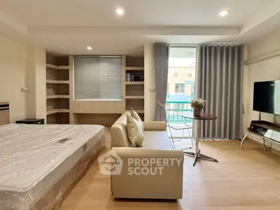 Modern studio apartment with cozy living area and natural light