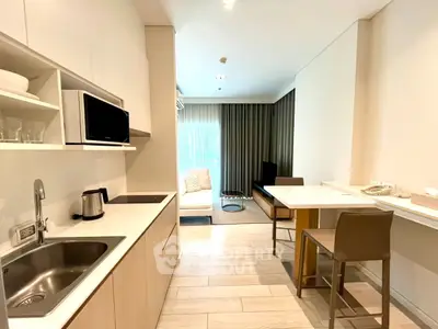 Modern open-layout kitchen and living area with sleek design and natural light.