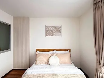 Cozy bedroom with elegant decor and soft lighting, perfect for relaxation.