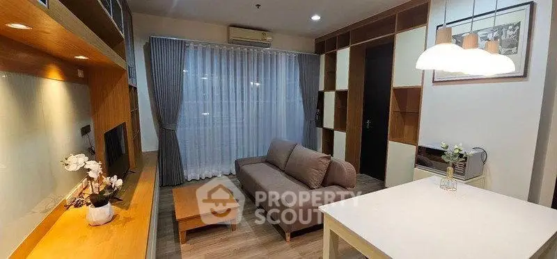 Modern living room with cozy sofa, wooden shelves, and elegant lighting in a stylish apartment.