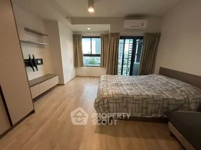 Spacious bedroom with modern decor and large windows offering city views