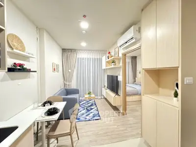 Modern open-plan living room with cozy seating and stylish decor in a bright apartment.