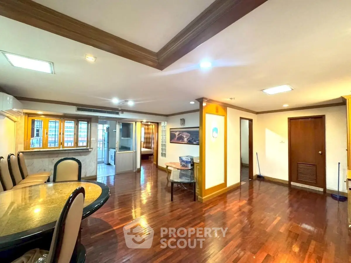 Spacious living room with elegant wooden flooring and modern dining area