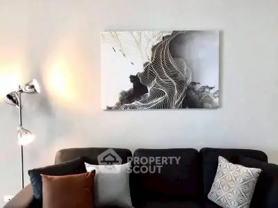 Modern living room with stylish sofa and abstract wall art.