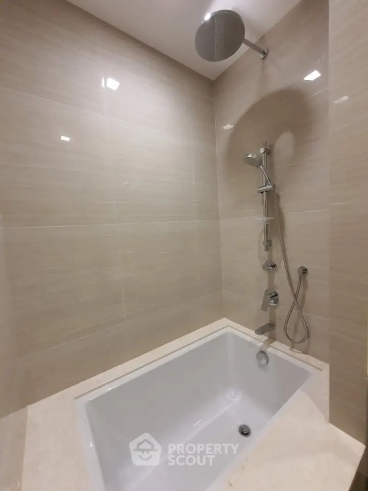 Modern bathroom with sleek bathtub and rainfall showerhead