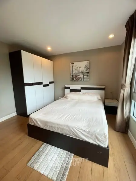 Modern bedroom with stylish decor and ample natural light