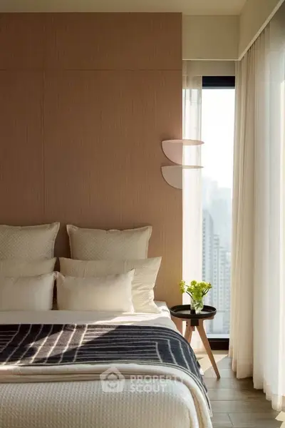 Luxurious bedroom with modern decor and city view, featuring elegant bedding and natural light.