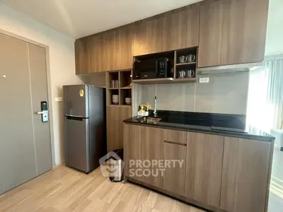 Modern kitchen with sleek wooden cabinets and stainless steel appliances