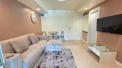 Cozy living room with modern furniture and wall-mounted TV