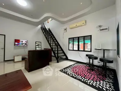 Modern living room with stylish staircase and contemporary decor