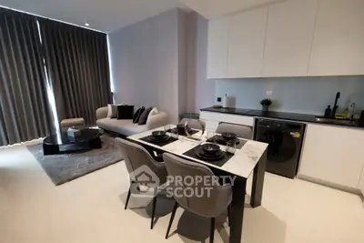 Modern open-layout living room and kitchen with stylish furniture and appliances