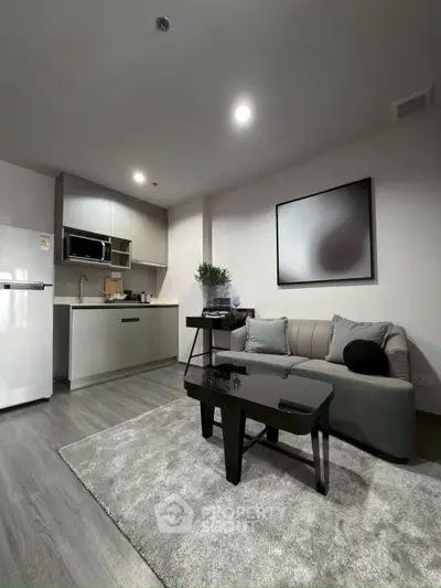 Modern living room with sleek kitchen and stylish decor